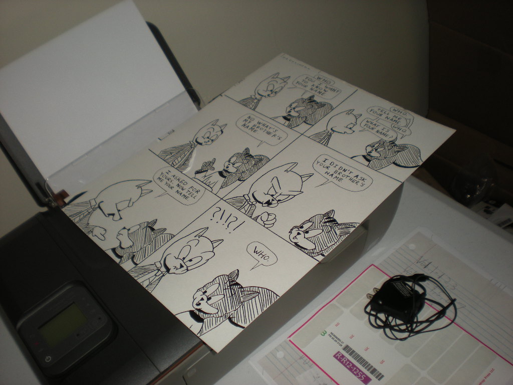 Inked comics pages drying