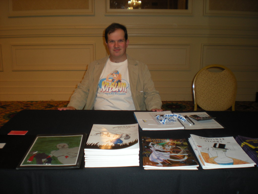 Max West behind his artist alley table